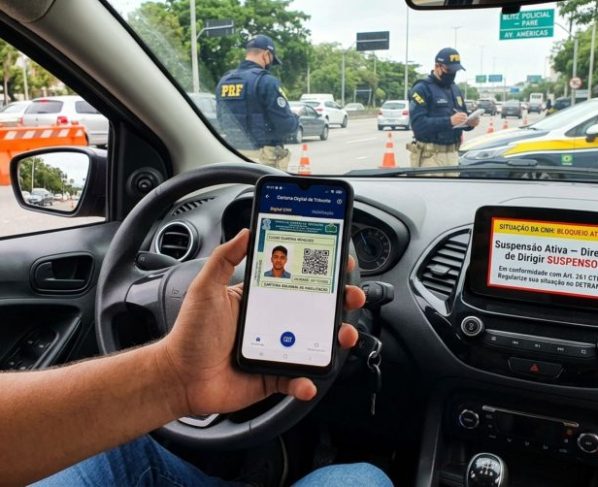 Motorista é parado em blitz, mostra a CNH Digital e agente identifica suspensão do direito de dirigir no sistema, homem afirma que documento continua disponível no celular e questiona se pode seguir viagem